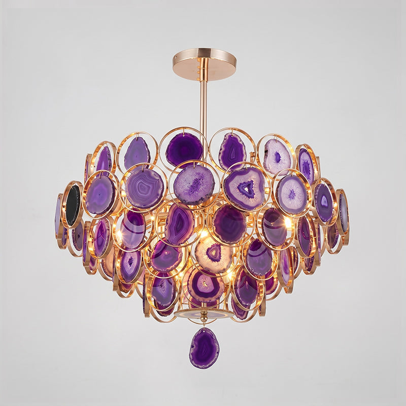 A Clérachic agate chandelier in purple tones on a grey backdrop, its slices ranging from lilac to deep violet.