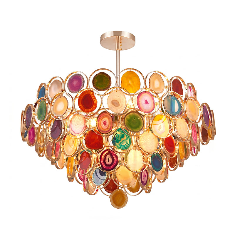 Multicolour Clérachic agate chandelier on white, with four lit tiers of red, green, amber and blue stone slices.