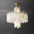 Clérachic Tiered Alabaster Chandelier lit against a charcoal wall, the veining in each slab showing through the light.