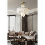 Clérachic Tiered Alabaster Chandelier lighting a large living room with sheer curtains and a pale sectional sofa.