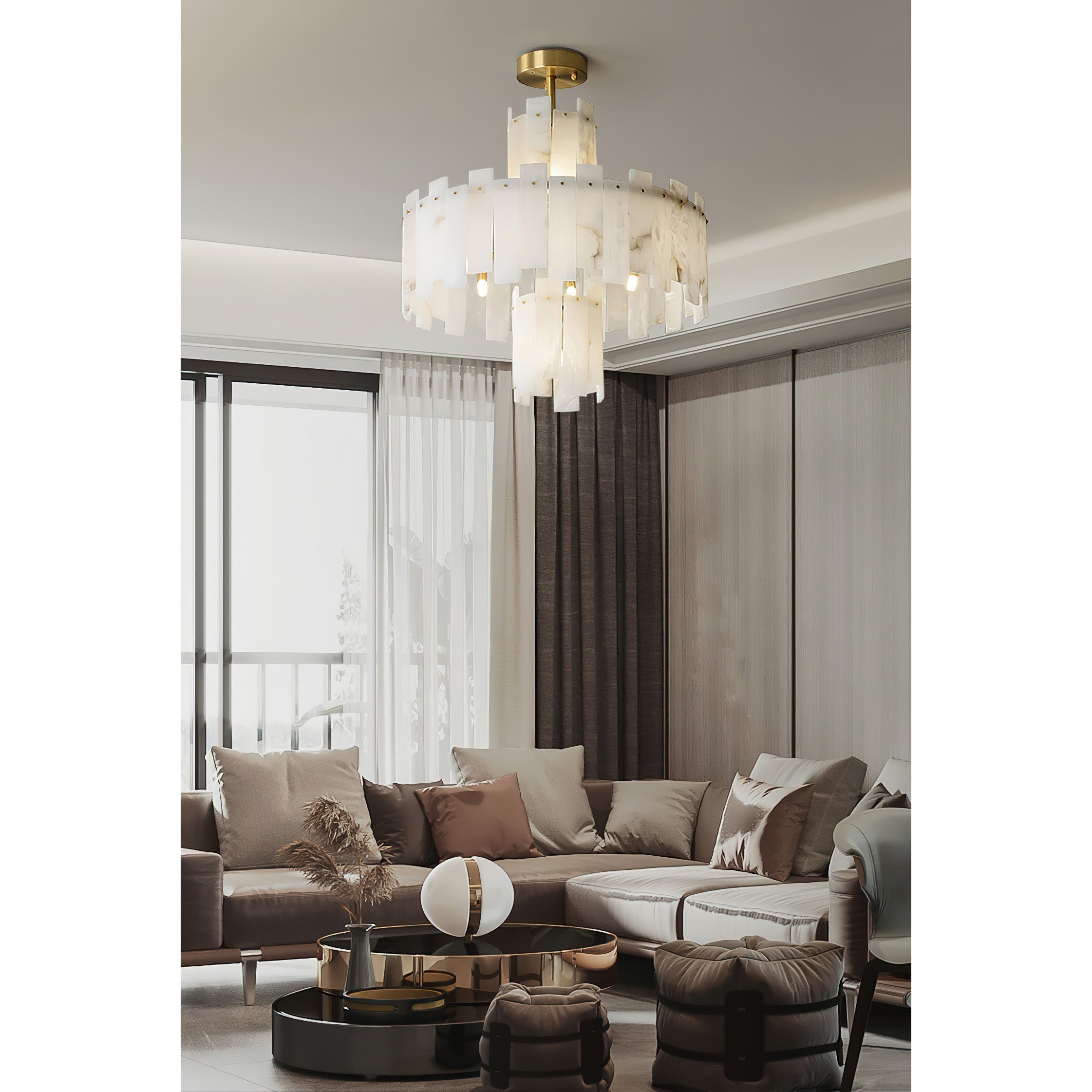 Clérachic Tiered Alabaster Chandelier lighting a large living room with sheer curtains and a pale sectional sofa.