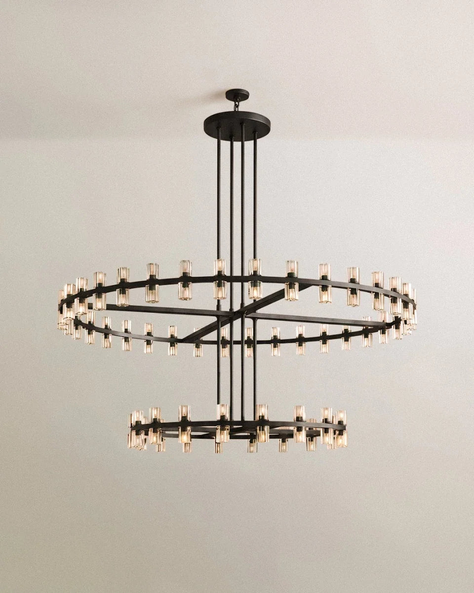 Clérachic two-tier chandelier in matte black, glass cylinders on a large and a small ring, hung from a round canopy on four rods.