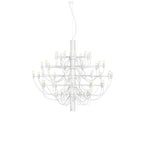 A large Clérachic chandelier in matt white with fine arms and bulbs, hanging on a white backdrop.