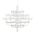 A large Clérachic chandelier in matt white, with several tiers of slim arms and exposed bulbs, on a white backdrop.