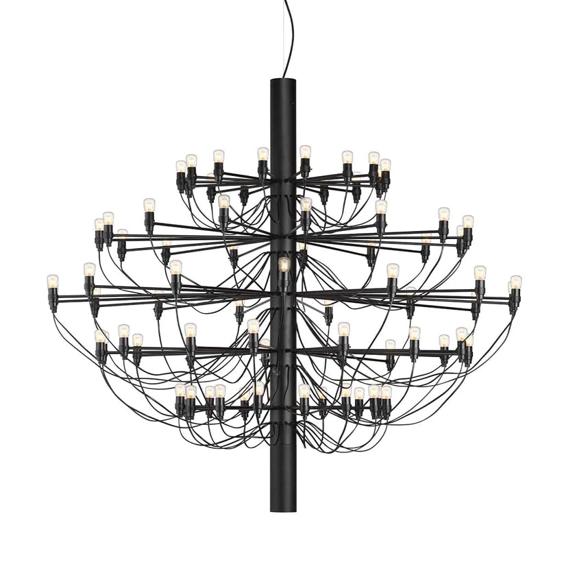 A large Clérachic chandelier in matt black, with many tiers of slim arms, looping cables and exposed bulbs, on white.