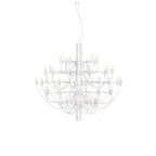 A mid-size Clérachic chandelier in matt white, with three tiers of slim arms and exposed bulbs, on white.