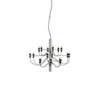 A small Clérachic chandelier with a chrome stem, black cables and exposed bulbs, on a plain white backdrop.