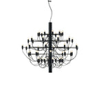 A mid-size Clérachic chandelier in matt black, with curving cable arms and exposed bulbs, on a plain white backdrop.