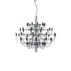 Another view of the chrome-stemmed Clérachic chandelier, with its tiered slim arms and looping cables, on white.