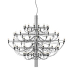 A large Clérachic chandelier with a chrome stem and many tiers of arms, shown full length on a white backdrop.