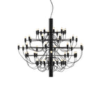 A fuller Clérachic tiered chandelier in matt black, with more arms and bulbs than the compact version, on a white backdrop.