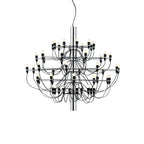 This fuller Clérachic chandelier has a chrome stem and several tiers of curving black cables, shown on white.