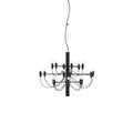 A small Clérachic chandelier in matt black, with two tiers of slim arms and a short stem, on a white backdrop.