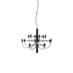 A small Clérachic chandelier in matt black, with two tiers of slim arms and a short stem, on a white backdrop.