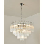 Lit Clérachic chandelier with chrome fittings, its stepped tiers of fluted glass rods shining in a room corner.