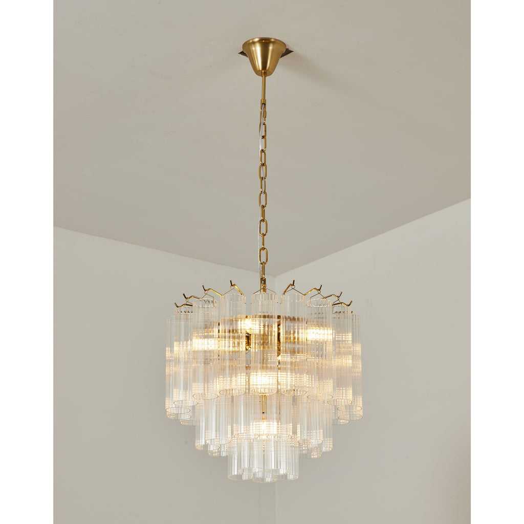 Gold-toned Clérachic chandelier lit from within, clear glass rods stepping down in tiers from a slim chain and ceiling cup.