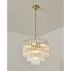 Gold-toned Clérachic chandelier lit from within, clear glass rods stepping down in tiers from a slim chain and ceiling cup.