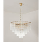 Unlit wide Clérachic chandelier, its five stepped rings of ribbed clear glass showing a gold-toned frame inside.