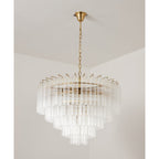 Large Clérachic chandelier, off, its tiers of clear glass tubes spreading wide beneath a gold-toned canopy.