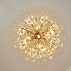 View from below of this Clérachic chandelier, showing the circular glass rod ends fanning out around a gold-toned centre.