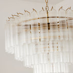 Detail of the rim of this Clérachic chandelier, with small gold-toned hooks holding the tall ribbed glass rods in place.