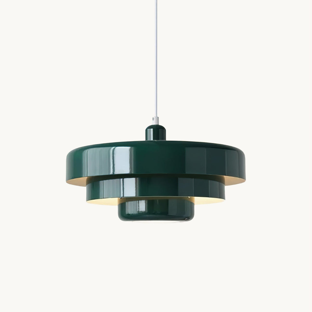 This Clérachic tiered disc pendant in dark green on a plain white backdrop, with three stacked steel tiers and a white cord.