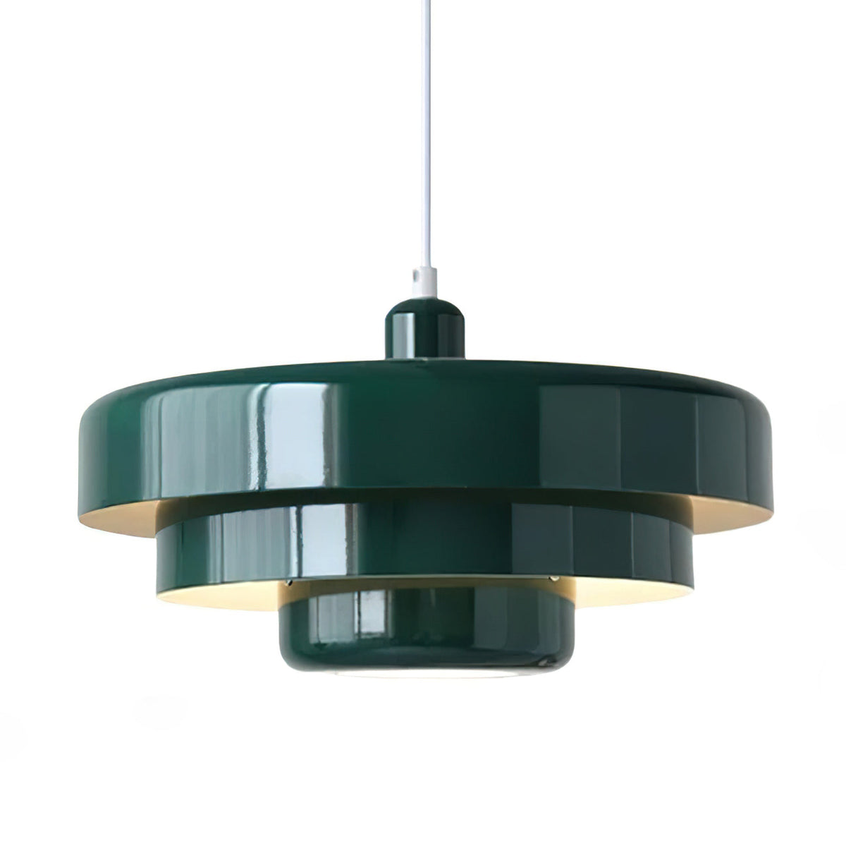 A dark green Clérachic tiered pendant on a white cord against a white backdrop, with its glossy tiers and warm light inside.
