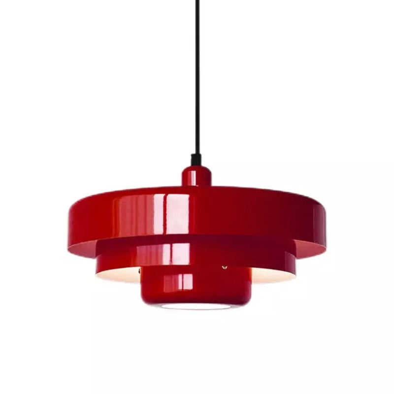 A red Clérachic tiered pendant on a black cord against a white backdrop, with three glossy tiers and a lit underside.