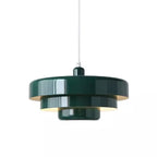 A dark green Clérachic tiered pendant on a white cord against a white backdrop, showing three tiers with a pale inner shade.