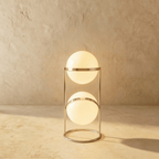 Clérachic two-globe sphere lamp in silver, both globes lit on a slim frame that stands on a closed ring base.