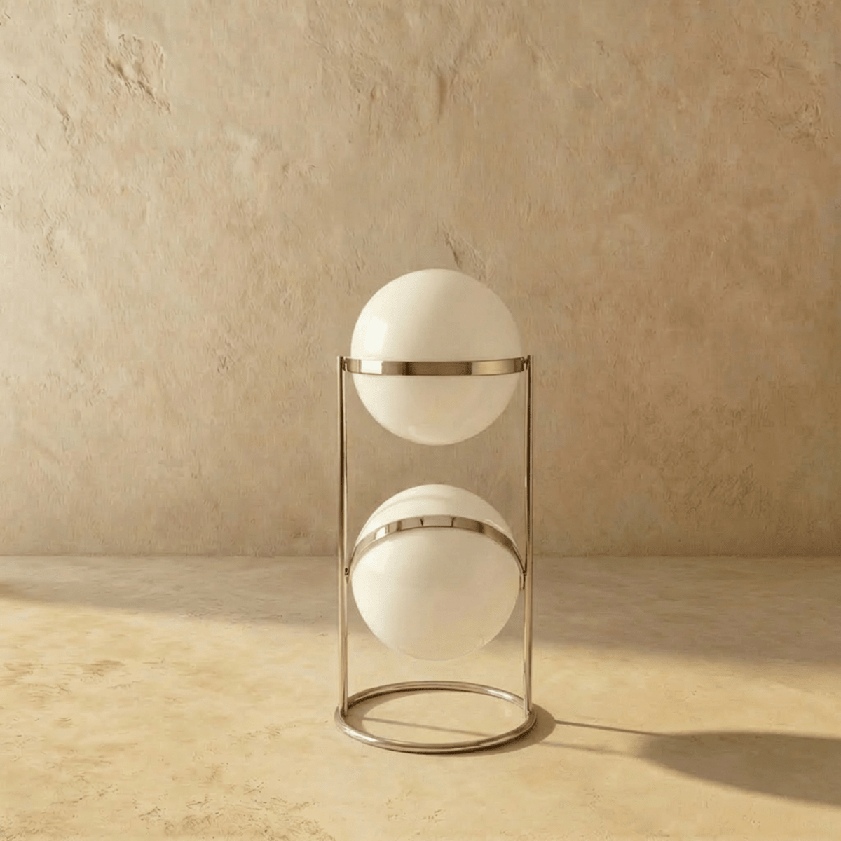Clérachic two-globe sphere lamp in silver, shown unlit, the white globes carrying a single hard highlight from the studio light.