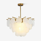 Tiered frosted glass disc chandelier from Clérachic on a short brass-toned rod, lit warmly, on a plain white backdrop.