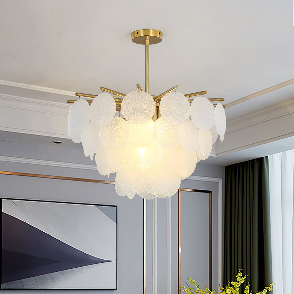 This Clérachic chandelier hangs low in a grey room with picture rails, its frosted glass discs lit softly from within.