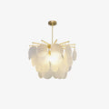 Clérachic chandelier of rippled glass discs lit warmly on a pale studio backdrop, hung from a brass rod and canopy.