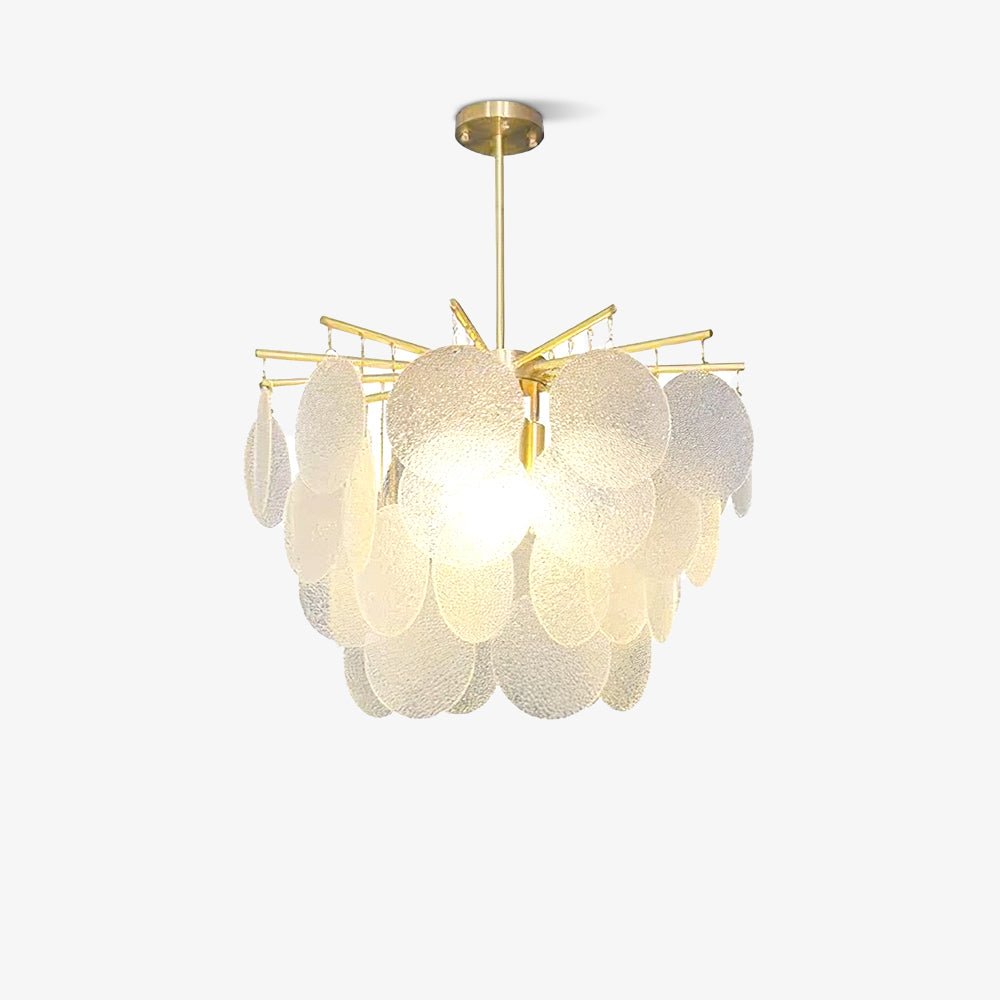 This Clérachic chandelier lit gently on a light backdrop, its brass-toned arms holding overlapping textured glass discs.