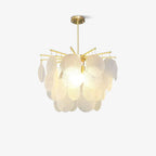 This Clérachic chandelier lit gently on a light backdrop, its brass-toned arms holding overlapping textured glass discs.