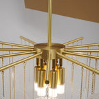 Underside view of the brass hub on this Clérachic chandelier, with the bulbs and the hanging chains holding the discs.