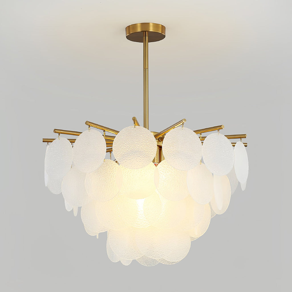 This Clérachic chandelier lit on a grey backdrop, its large frosted discs overlapping in tiers beneath a brass rod.