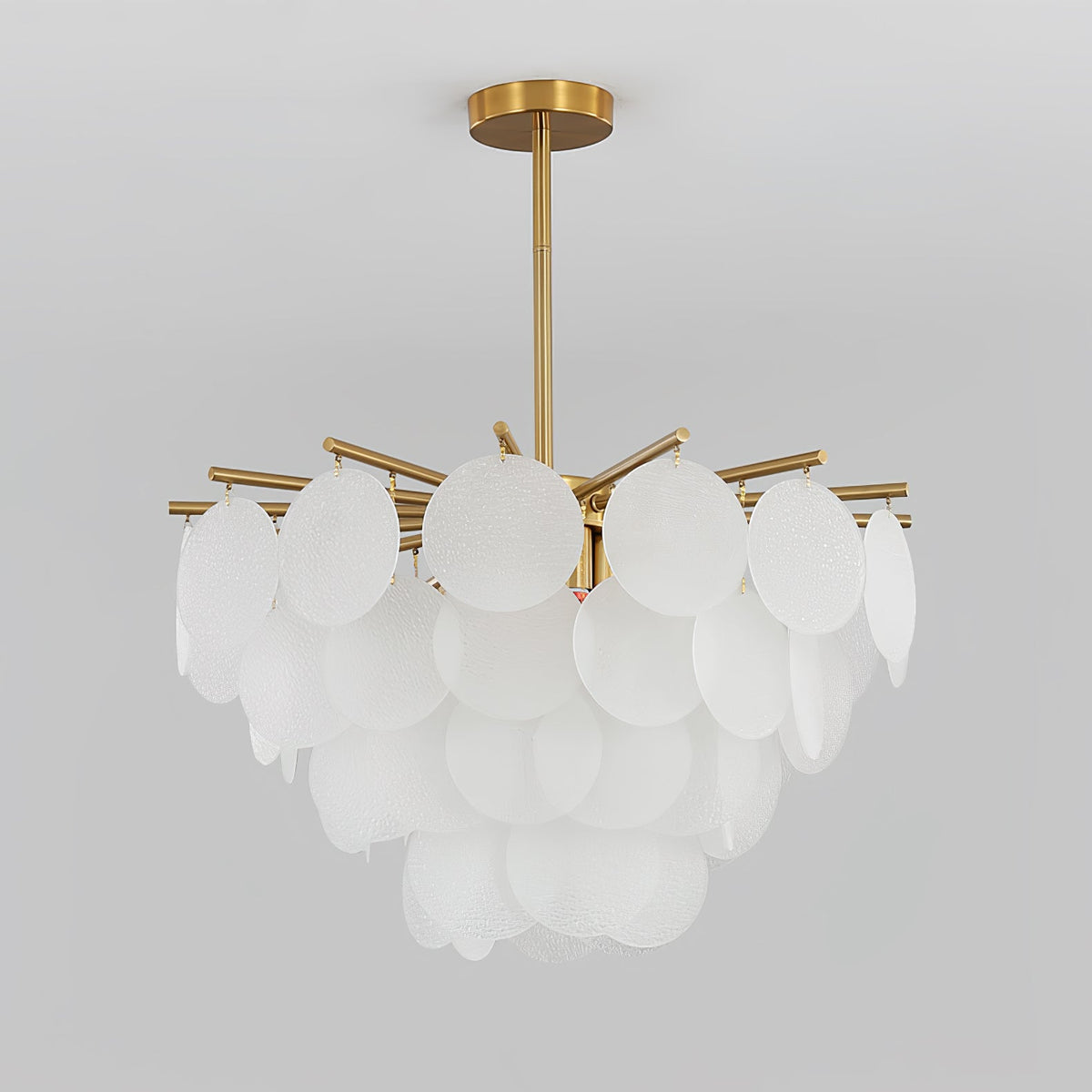 Unlit Clérachic chandelier of frosted glass discs against a pale grey backdrop, the tiers of discs clearly separate.