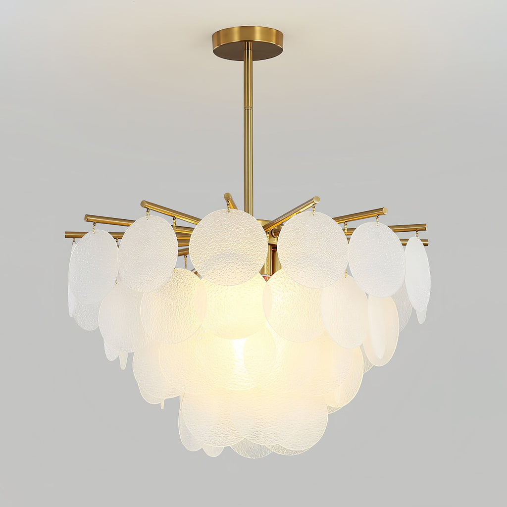Clérachic chandelier lit warmly on a grey backdrop, with large frosted discs on brass-toned arms and a short brass rod.