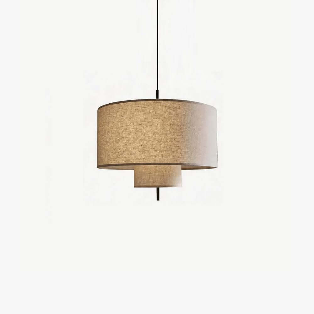 Clérachic pendant with a wide woven linen drum shade and a smaller tier beneath it, hung from a black cord on a plain white backdrop.