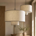 Close view of the woven linen texture and layered tiers on two Clérachic pendants of different sizes, hung side by side.