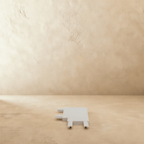 Clérachic track connector in white, the flat corner piece photographed from above on a plaster floor.