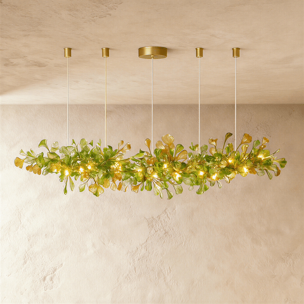 Clérachic's chandelier in its linear form, green glass leaves clustered along a brass branch on rods.