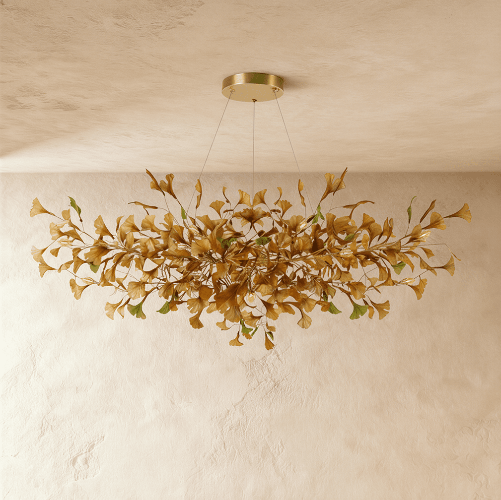 Clérachic's chandelier in its round form, glowing warm through a dense cluster of amber glass leaves.
