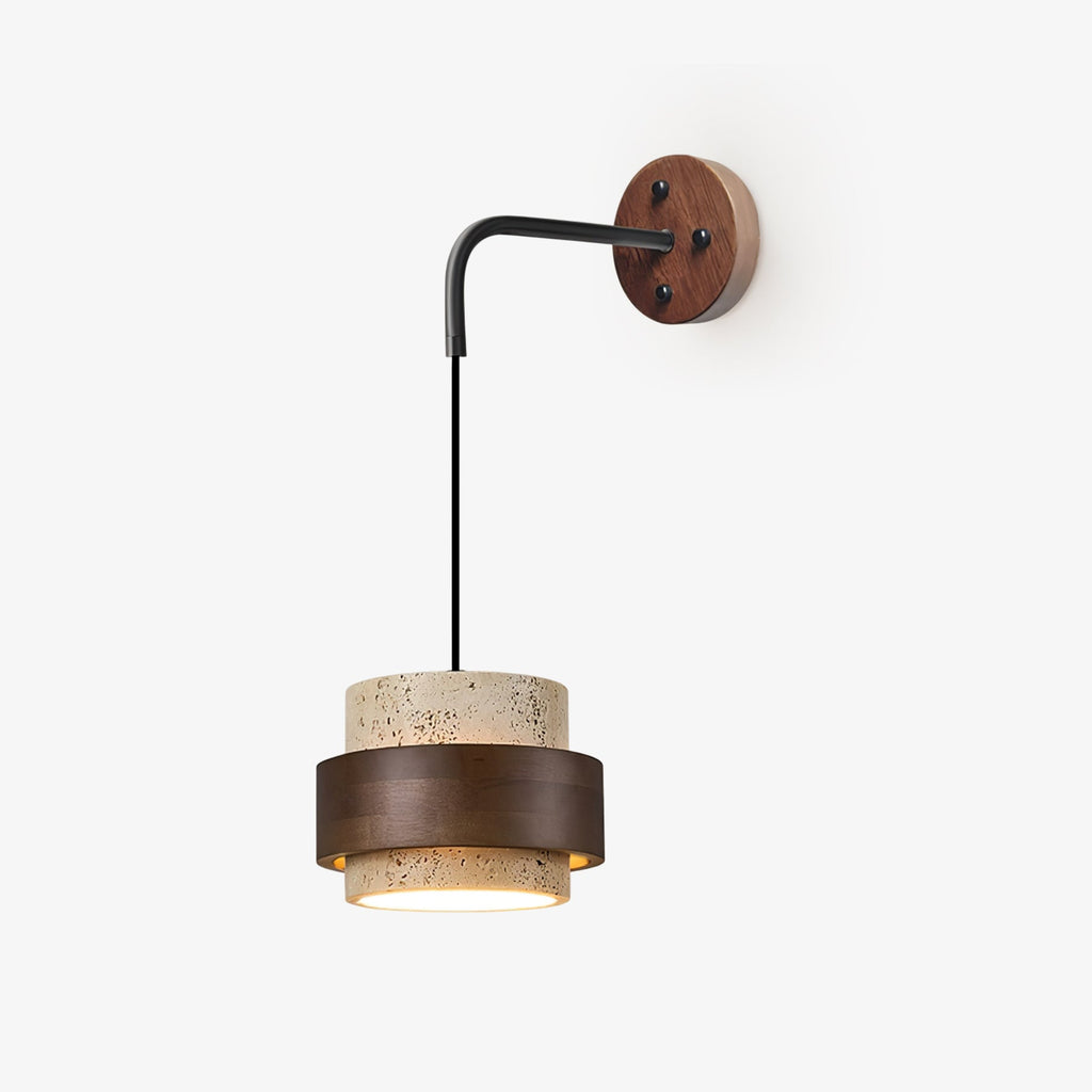 A Clérachic wall light on a plain pale backdrop, with a black arm, round walnut plate and a travertine shade ringed in dark walnut.