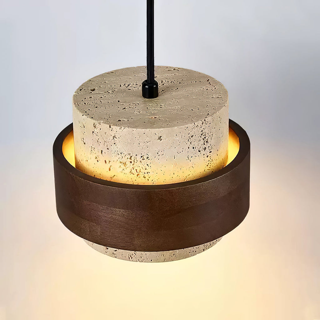 Close view from below of the travertine drum and dark walnut ring on this Clérachic wall light, with the lit underside glowing gold.