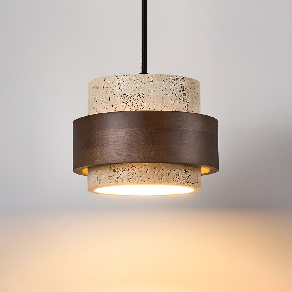 Straight-on close view of this Clérachic wall light shade lit from below, throwing a warm wash of light across the wall beneath.