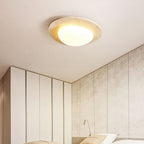 Ceiling light from Clérachic in a corner of a room with white wardrobe doors and textured stone-effect wall panels, softly lit.