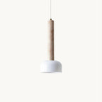 A Clérachic pendant light on a plain white backdrop, a slim beige travertine column ending in a glossy white half-dome shade.